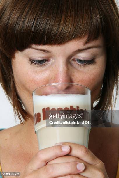 Germany; young woman drinking a glass of Coffe / Latte Macciato - 2007