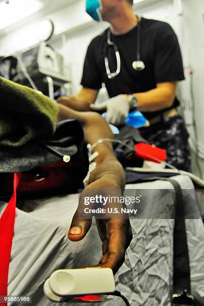 In this handout image provided by the U.S. Navy, medical staff aboard the Nimitz-class aircraft carrier USS Carl Vinson monitor the vital signs of a...