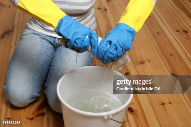 Young woman is cleaning the floor -