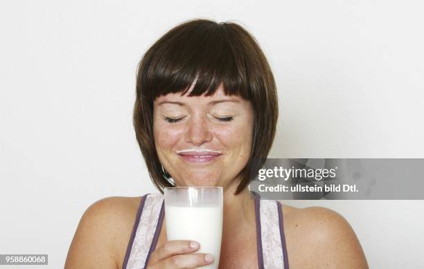 Germany; young woman drinking milk - 2007