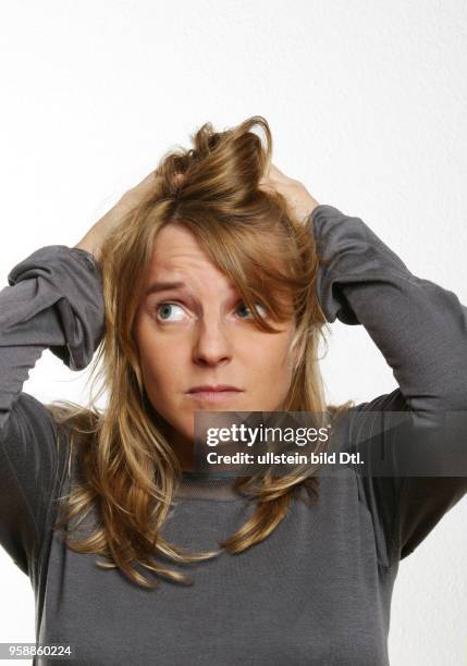 Young woman is tearing her hair -