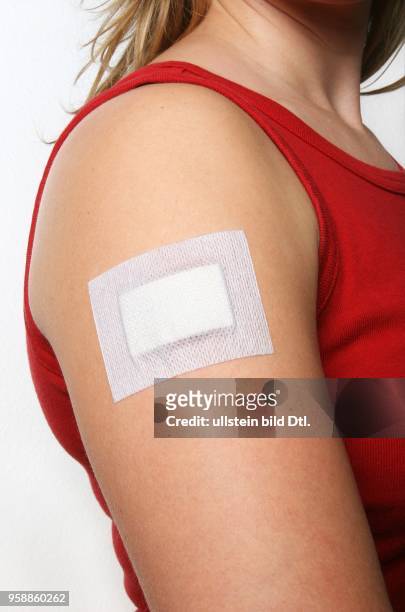 Young woman with a plaster at her arm -