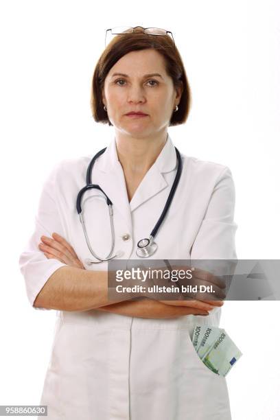 Female doctor with stethoscope and Euro banknotes in her pocket -