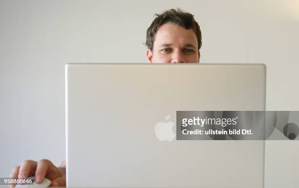 Young man is working with a laptop -