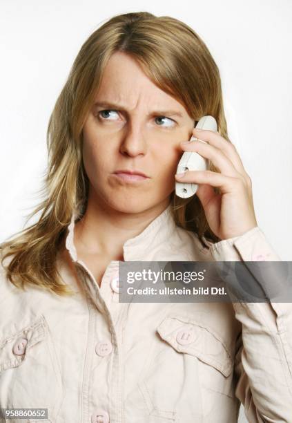 Young woman with a telephone and is angry -