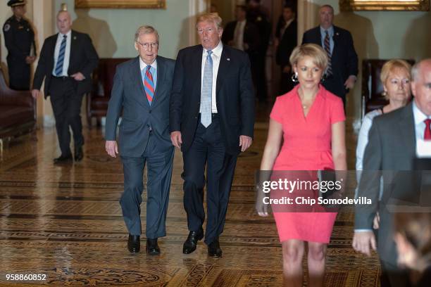 President Donald Trump is escorted by Senate Majority Leader Mitch McConnell to the weekly Senate Republican policy luncheon at the U.S. Capitol May...