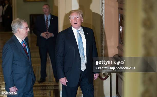 President Donald Trump answers questions about first lady Melania Trump as he is escorted by Senate Majority Leader Mitch McConnell to the weekly...