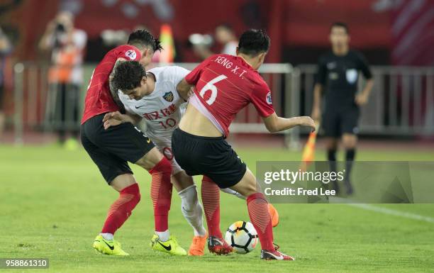 Alexandre Pato of Tianjin Quanjian and Zhang Lin peng of Guangzhou Evergrande in action during the AFC Champions League Round of 16 second leg match...