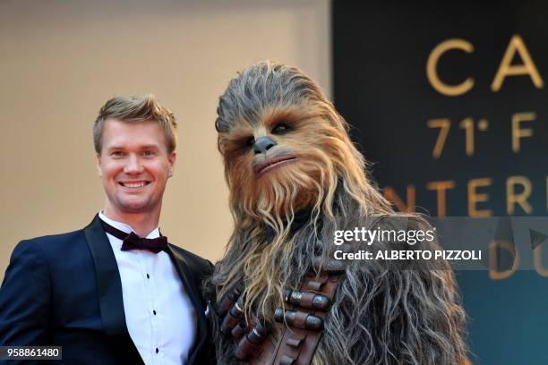 Finnish actor Joonas Suotamo who plays Chewbacca poses with Chewbacca as they arrive on May 15, 2018 for the screening of the film "Solo : A Star...