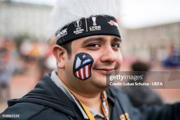 Fan of Atletico de Madrid pose with the logo on this face at the Fan Zone ahead of the UEFA Europa League Final between Olympique de Marseille and...