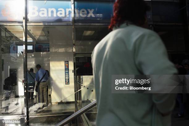 Customers stand in line to use automatic teller machines at a Banco Nacional de Mexico SA bank branch in Mexico City, Mexico, on Tuesday, May 15,...