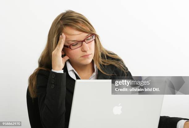 Young woman is working at an apple laptop -