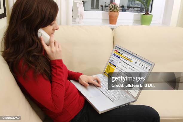 Woman with laptop sitting on the sofa is surfing in the internet on the homepage of the job agency JOBworld -