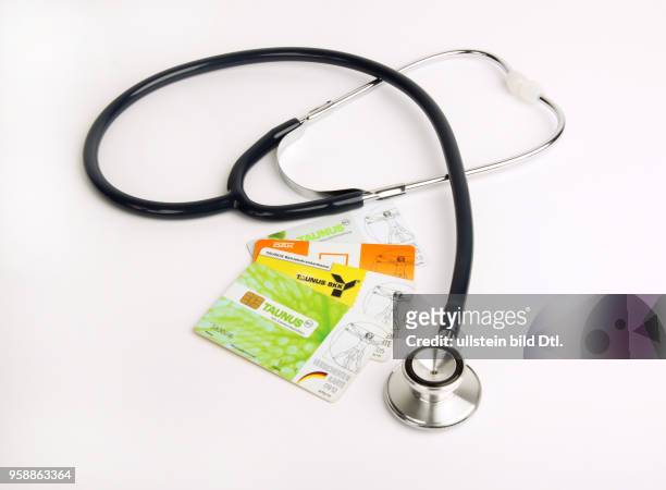 Germany - symbolic photo health insurence, health-care costs, stethoscope with insurance cards -