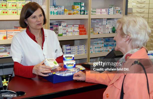 Germany Brandenburg Wriezen - pharmacy pharmacist is advising a customer -