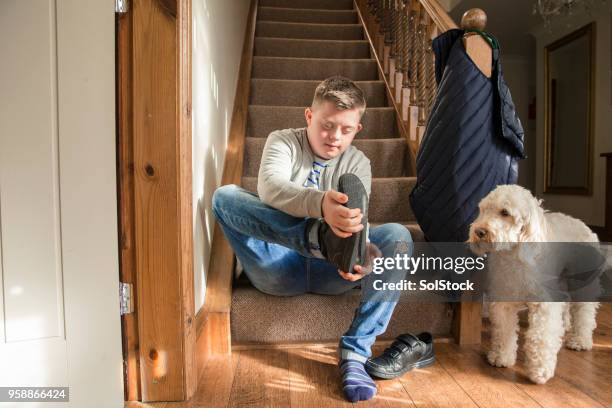 taking off his shoes - removing shoes stock pictures, royalty-free photos & images