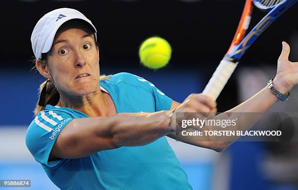 Justine Henin of Belgium eyes a return against Elena Dementieva of Russia in their women's singles second round match on day three of the Australian...