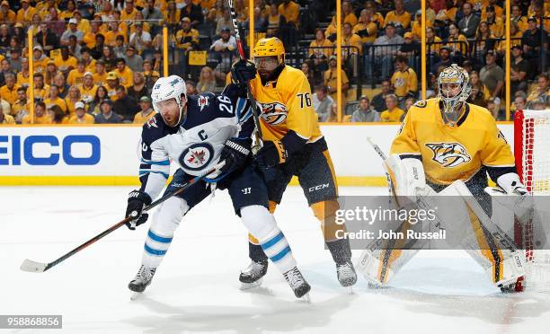 Blake Wheeler of the Winnipeg Jets battles against P.K. Subban and Juuse Saros of the Nashville Predators in Game Seven of the Western Conference...