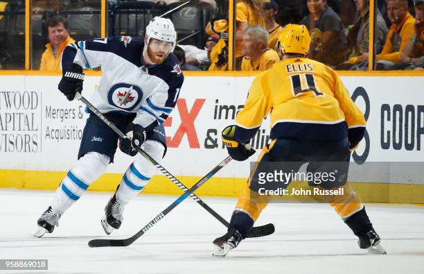 Adam Lowry of the Winnipeg Jets skates against Ryan Ellis of the Nashville Predators in Game Seven of the Western Conference Second Round during the...