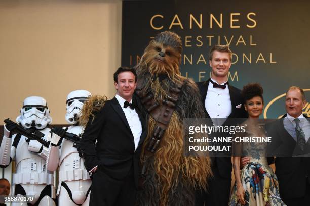 Producer Simon Emanuel, Chewbacca, Finnish actor Joonas Suotamo, British actress Thandie Newton and US actor Woody Harrelson pose as they arrive on...