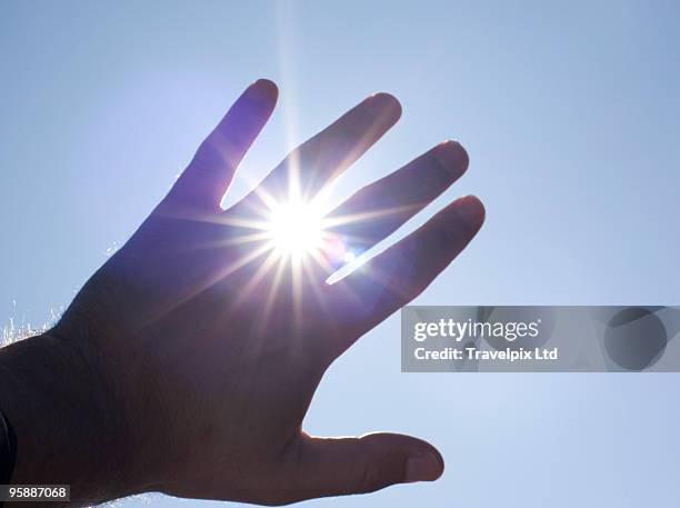 sunlight bursting through fingers - blocking stock pictures, royalty-free photos & images