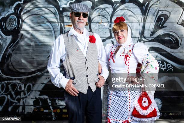 Spanish couple Esteban and Nieves dressed in traditional "chulapo" and "chulapa" garb for San Isidro celebrations pose in Madrid on May 15, 2018.