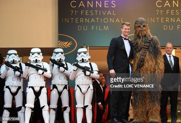 Finnish actor Joonas Suotamo who plays Chewbacca poses with Chewbacca as they arrive on May 15, 2018 with US actor Woody Harrelson for the screening...