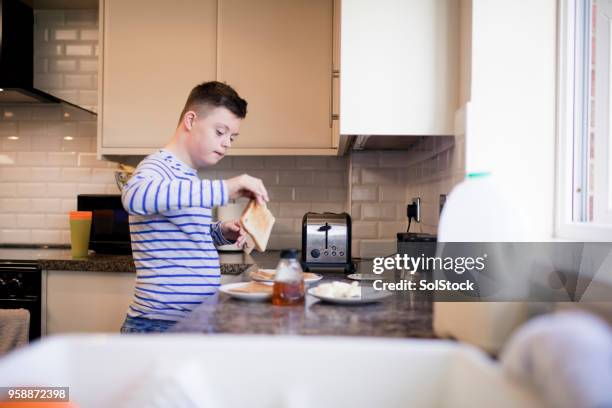 making toast - down syndrome cooking stock pictures, royalty-free photos & images