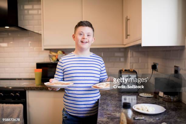 making toast - disabilitycollection stock pictures, royalty-free photos & images