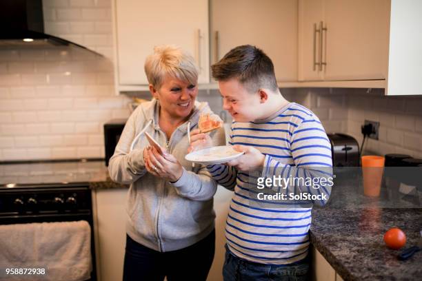 eating toast in the kitchen - persons with disabilities stock pictures, royalty-free photos & images