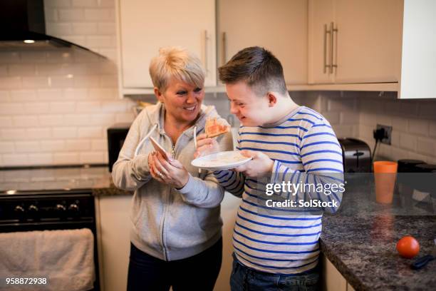 eating toast in the kitchen - family teenager stock pictures, royalty-free photos & images