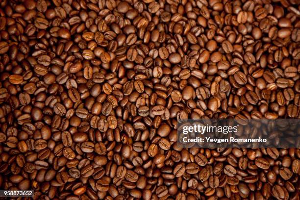 roasted brown coffee beans, can be used as a background and texture - grain texture stock pictures, royalty-free photos & images