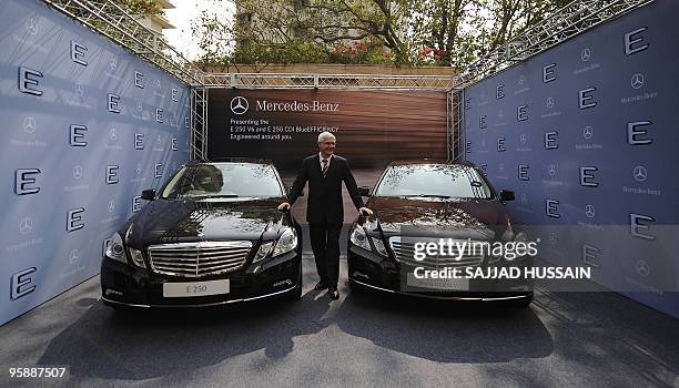Managing director and CEO of Mercedes-Benz India, Wilfried G Aulbur poses with the E-class model series E 250 V6 and E 250CDI blue efficiency...