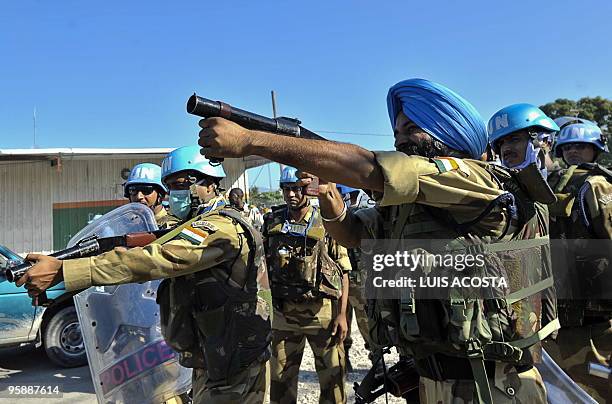 Pakistani soldiers try to dispers a crowd during a protest in front of the international airport in Port au Prince on 18 January, 2010. UN chief Ban...