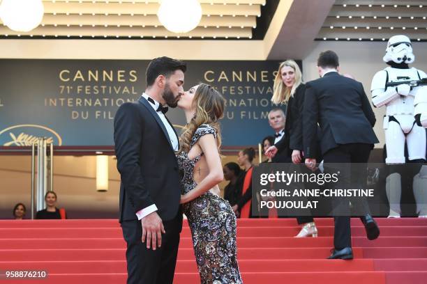 French-Swiss model Nabilla Benattia and her partner Thomas Vergara kiss as they arrive on May 15, 2018 for the screening of the film "Solo : A Star...