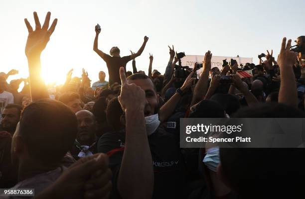 People cheer as Hamas leader Ismail Haniya speaks to protesters at the border fence with Israel on May 15, 2018 in Gaza City, Gaza. Israeli soldiers...