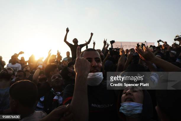 People cheer as Hamas leader Ismail Haniya speaks to protesters at the border fence with Israel on May 15, 2018 in Gaza City, Gaza. Israeli soldiers...