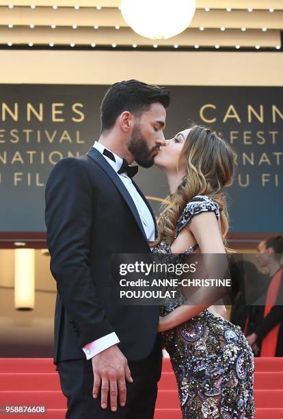 French-Swiss model Nabilla Benattia and her partner Thomas Vergara kiss as they arrive on May 15, 2018 for the screening of the film "Solo : A Star...