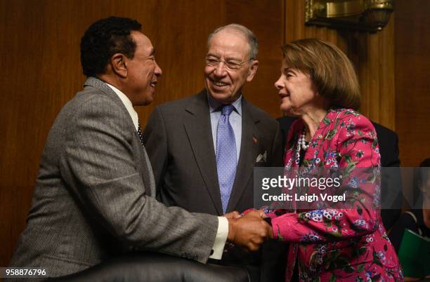 Singer and songwriter Smokey Robinson speaks with Senator Dianne Feinstein and Senator Chuck Grassley prior to the Senate Judiciary Committee during...