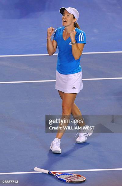 Justine Henin of Belgium celebrates winning match point against Elena Dementieva of Russia in their women's singles second round match on day three...