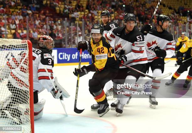 Darcy Kuemper of Team Canada, Yasin Ehliz of Team Germany and Bo Horvat of Team Canada during the IIHF World Championship game between Canada and...