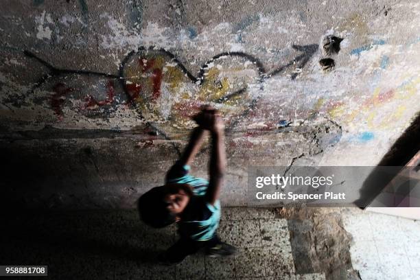 Child walks through a hallway at the home of eight-month-old Leila Anwar Ghandoor, who died in the hospital on Tuesday morning from tear gas...