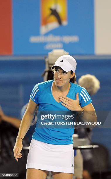 Justine Henin of Belgium gestures to thank the crowd following her victory over Elena Dementieva of Russia in their women's singles second round...