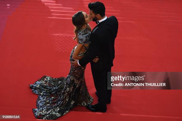 French-Swiss model Nabilla Benattia and her partner Thomas Vergara kiss as they arrive on May 15, 2018 for the screening of the film "Solo : A Star...