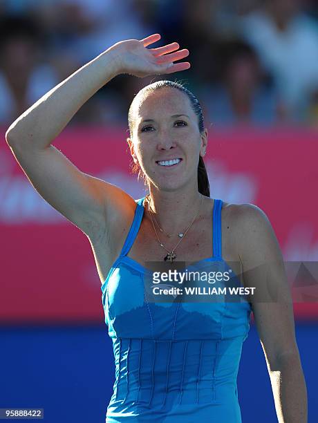 Serbian tennis player Jelena Jankovic waves to the crowd after victory in her women's singles match against British opponent Katie O'Brien on the...
