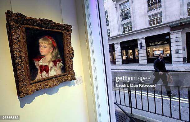 Work entitled 'Mademoiselle grimprel au ruban rouge' by Pierre Auguste Renoir hangs in Christie's showroom on January 20, 2010 in London, England....