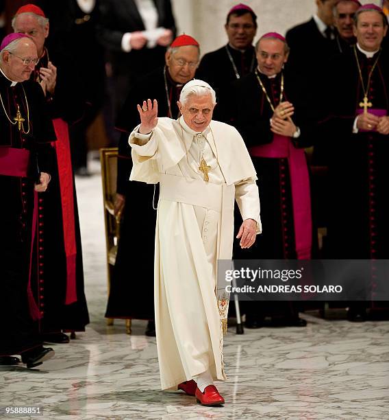 Pope Benedict XVI waves to the faithful gathered in Aula Paolo VI at the Vatican as he arrives for his weekly general audience on January 20, 2010 ....