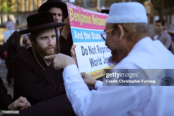 An orthodox Jew and a muslim take part in friendly debate during a protest against Israel in Whitehall on May 15, 2018 in London, England. Israeli...