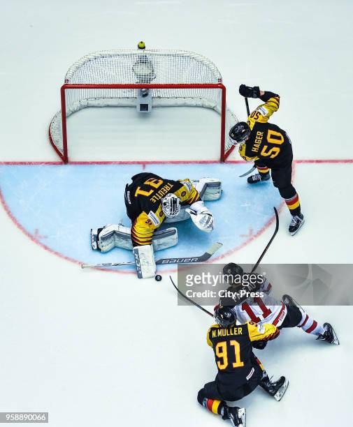 Niklas Treutle, Moritz Mueller of Team Germany, Jean-Gabriel Pageau of Team Canada and Patrick Hager of Team Germany during the IIHF World...