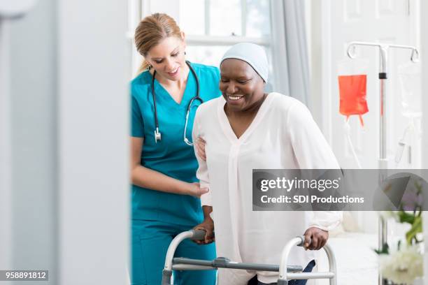 nurse helps patient walk - advance 2018 exam stock pictures, royalty-free photos & images